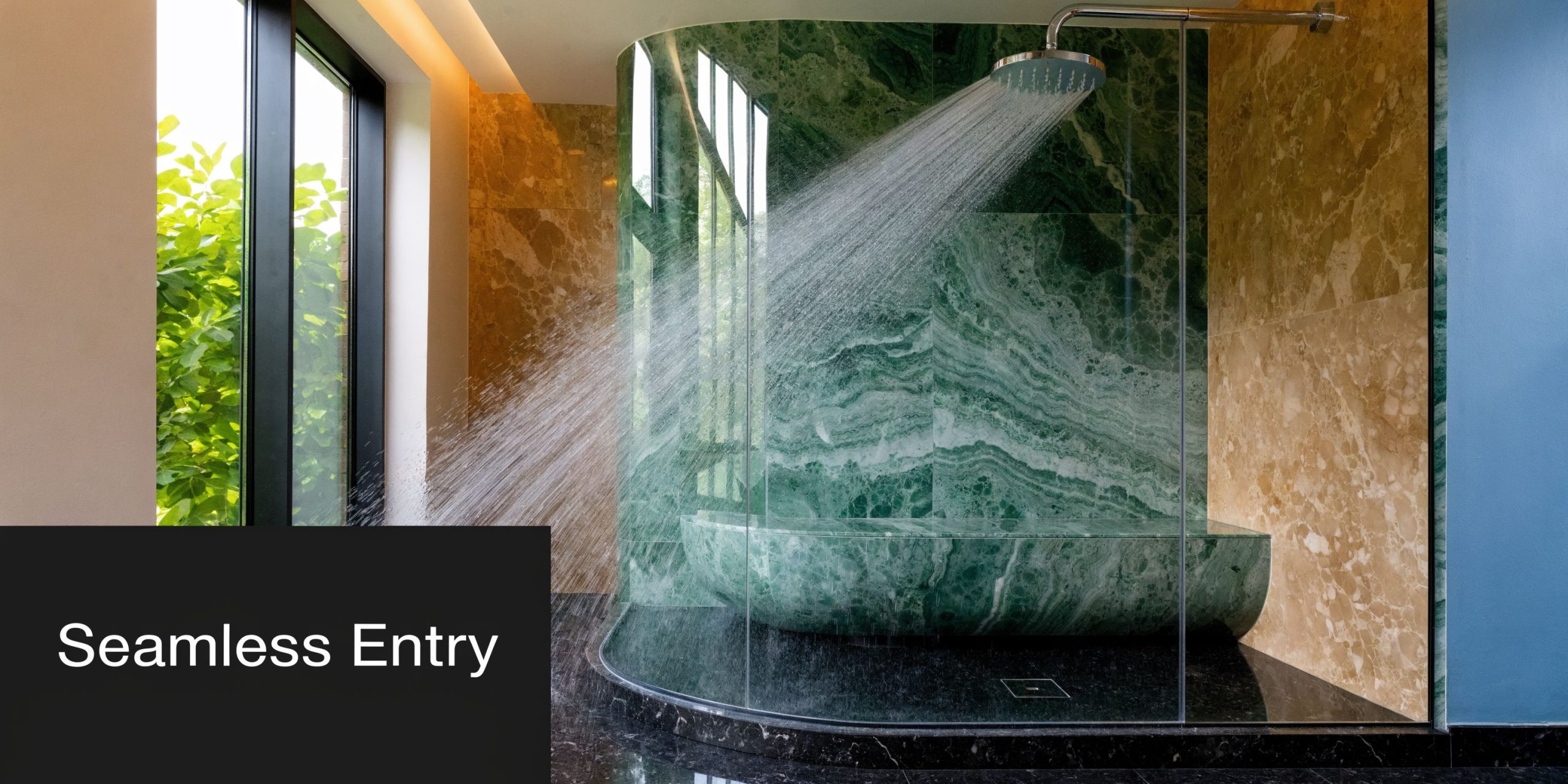 A luxurious bathroom featuring a green marble bathtub inside a seamless glass walk-in shower area.